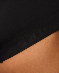 Woman wearing Flow Bonded Scoop Neck Sports Bra - Black | Model:Rosie | Size:S | Thumbnail Index: 2