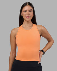 Woman wearing Flow Performance Tank 2.0 - Cantaloupe | Model:Rhiley | Size:S | Thumbnail Index: 0
