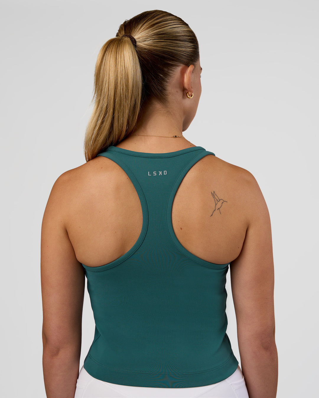 Woman wearing Flow Performance Tank 2.0 - Transformative Teal | Model:Myrte | Size:S - view 2