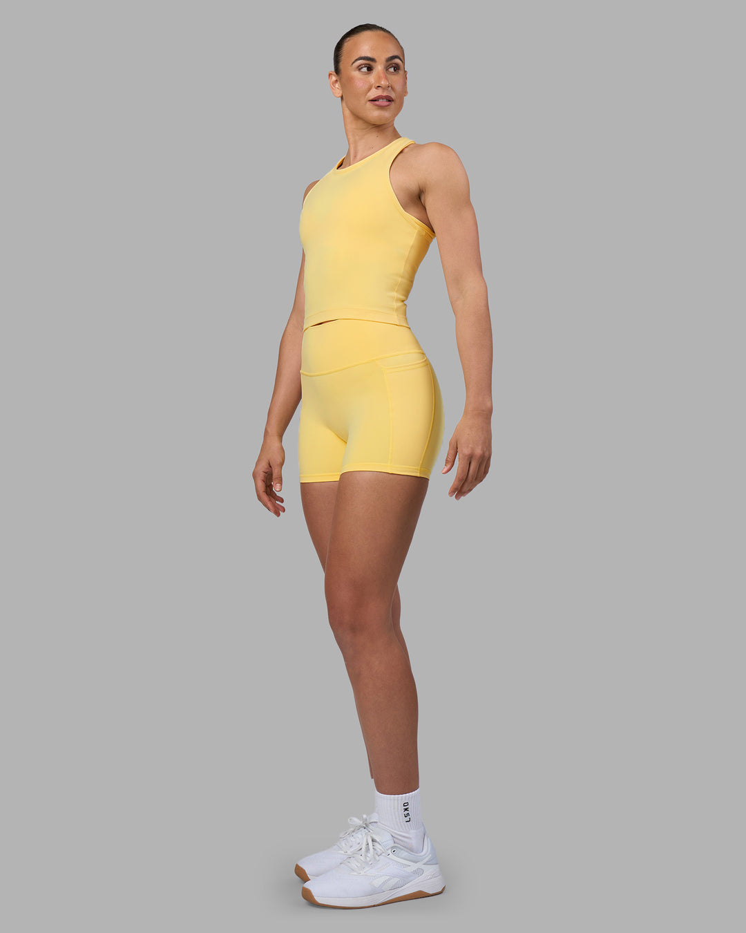 Woman wearing Flow Performance Tank 2.0 - Lemon | Model:Sophie | Size:S - view 4