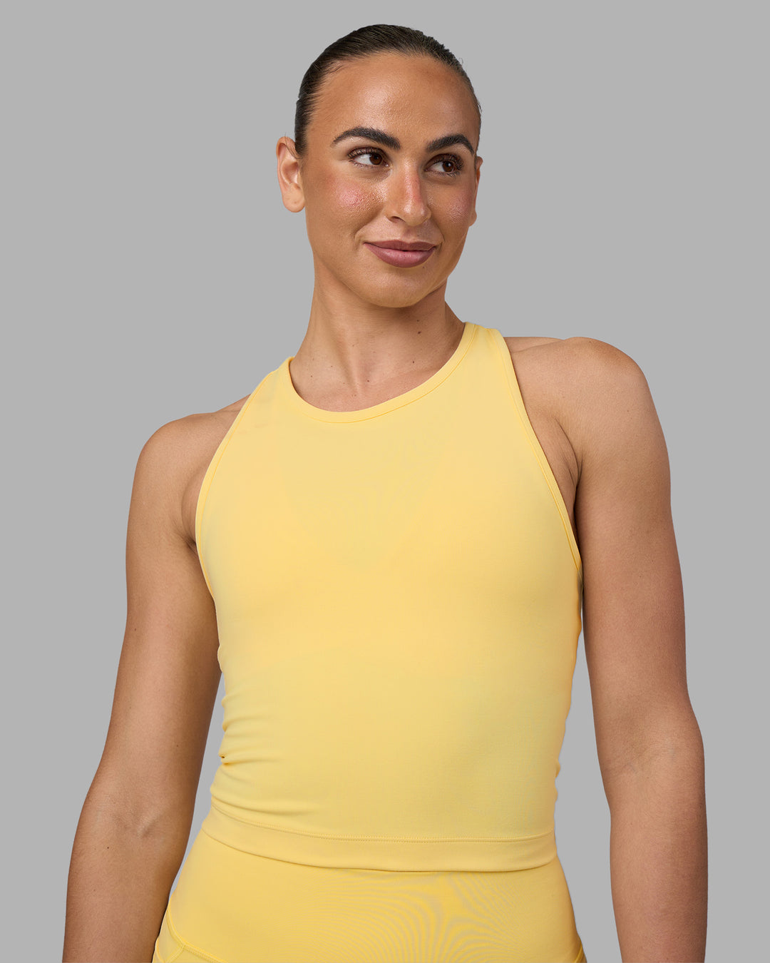Woman wearing Flow Performance Tank 2.0 - Lemon | Model:Sophie | Size:S - view 1