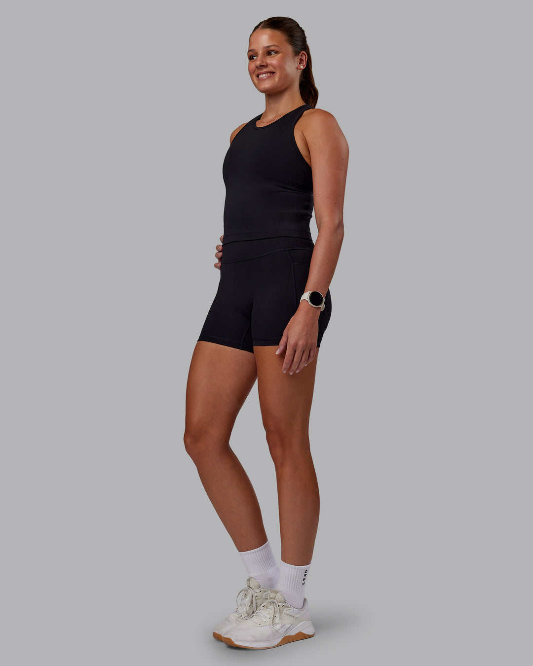 Woman wearing Flow Performance Tank - Black | Model:Phoebe | Size:S - view 3