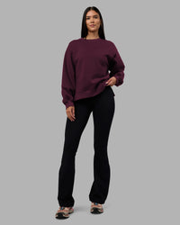 Woman wearing Full Form Fleece Sweater with Side Slits - Cherry Lacquer | Model:Rhiley | Size:S | Thumbnail Index: 0
