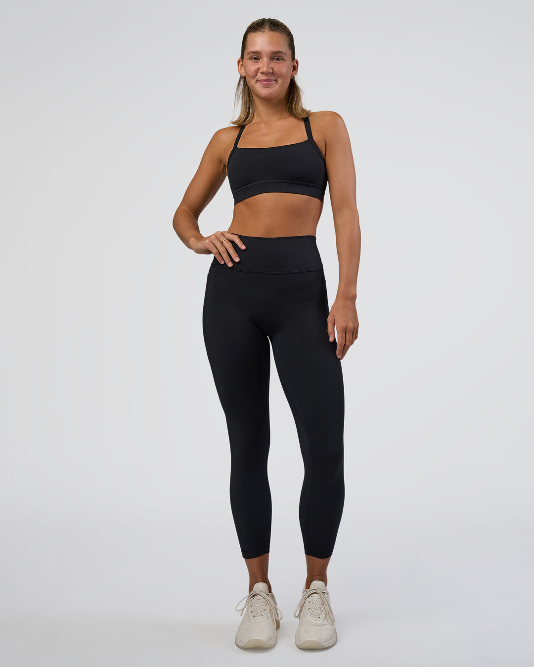 Woman wearing Fusion Ultra High-Rise 7/8 Legging Pockets - Black | Model:Amity | Size:S - view 2