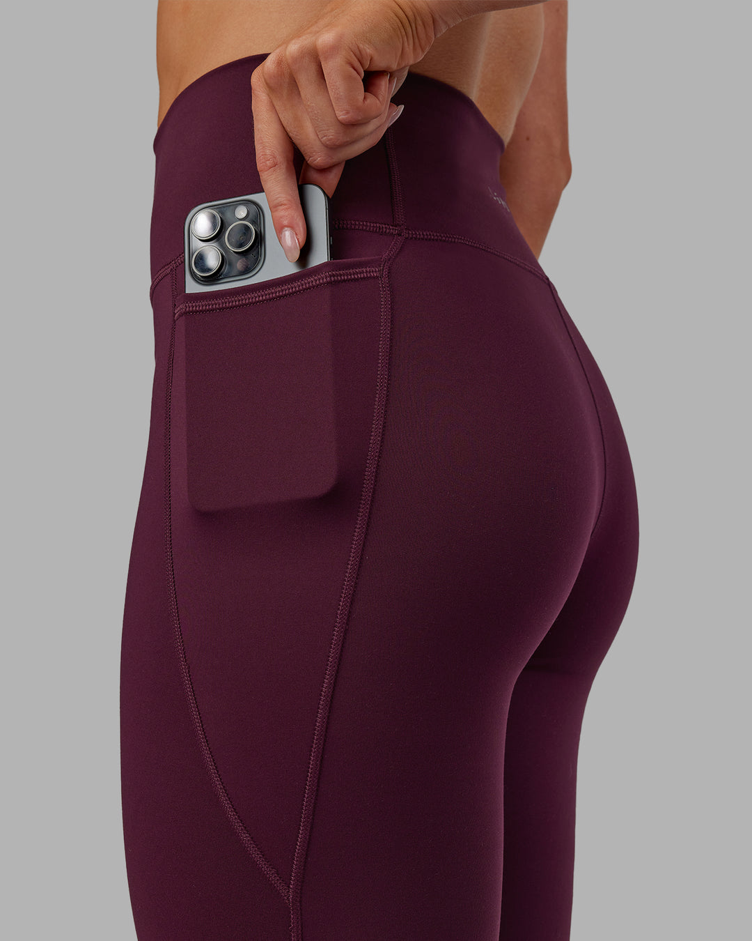 Woman wearing Fusion Ultra High-Rise 7/8 Legging Pockets - Cherry Lacquer | Model:Paris | Size:S - view 3