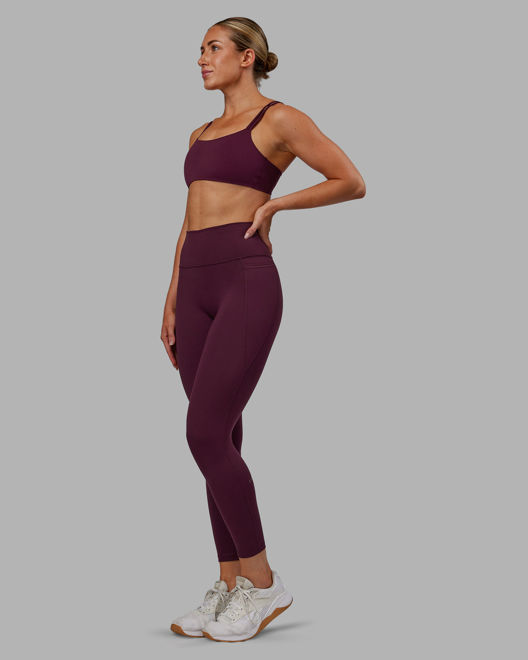 Woman wearing Fusion Ultra High-Rise 7/8 Legging Pockets - Cherry Lacquer | Model:Paris | Size:S - view 6