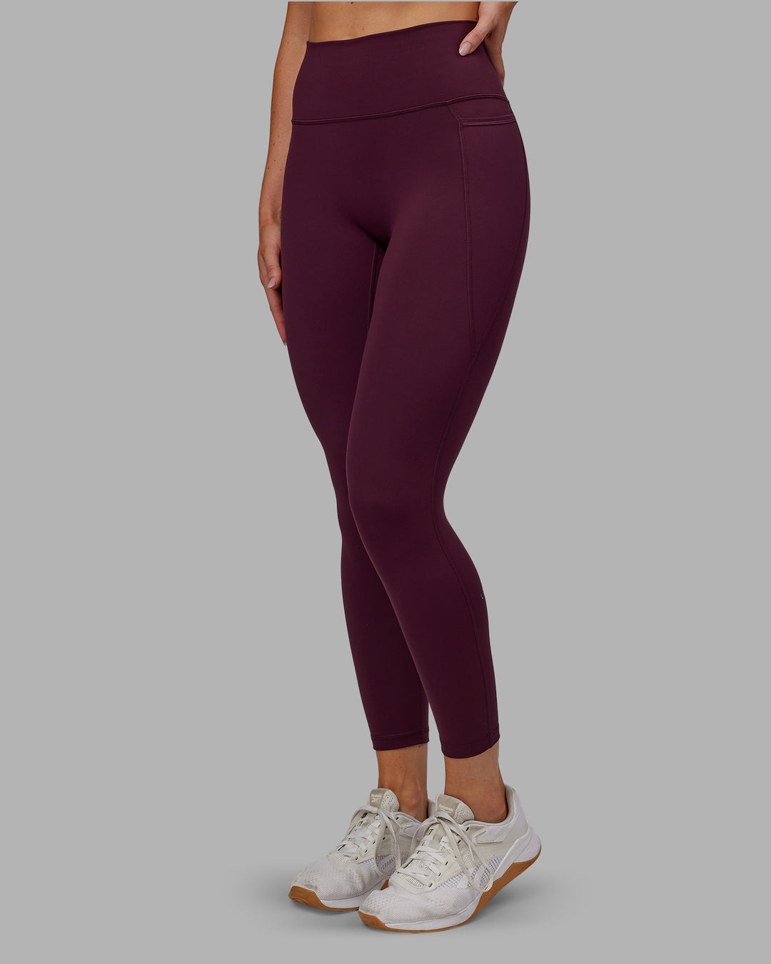 Woman wearing Fusion Ultra High-Rise 7/8 Legging Pockets - Cherry Lacquer | Model:Paris | Size:S - view 2
