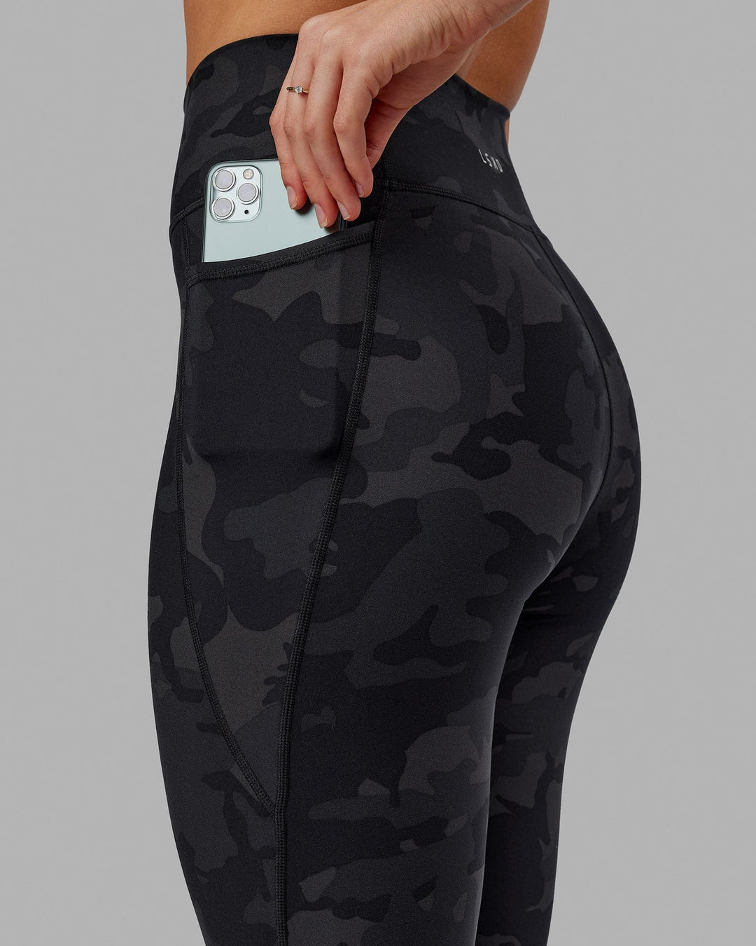 Woman wearing Fusion Ultra High-Rise 7/8 Legging Pockets - Black-Camo | Model:Katie | Size:S - view 7