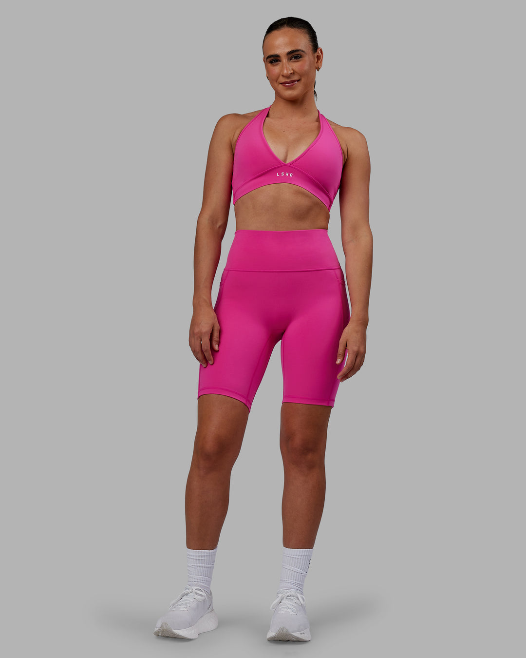 Woman wearing Fusion Ultra High-Rise 9" Short Pockets - Fuchsia Pink | Model:Sophie | Size:S - view 4
