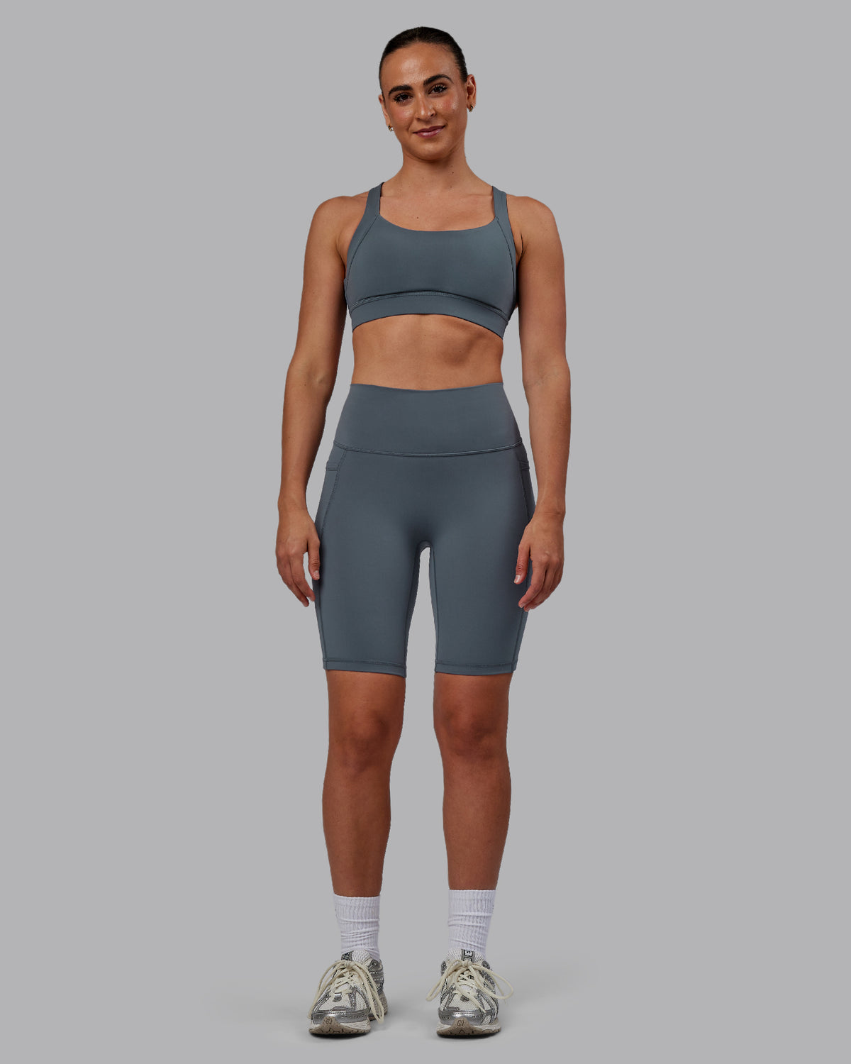 Woman wearing Fusion Ultra High-Rise 9" Short Pockets - Turbulence | Model:Sophie | Size:S