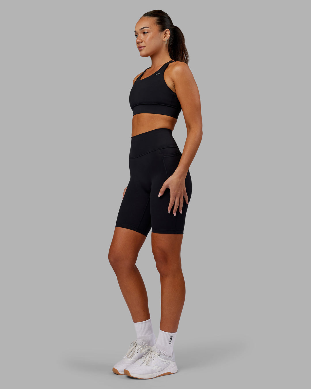 Woman wearing Fusion Ultra High-Rise 9" Short Pockets - Black | Model:Kirstyn | Size:S - view 5