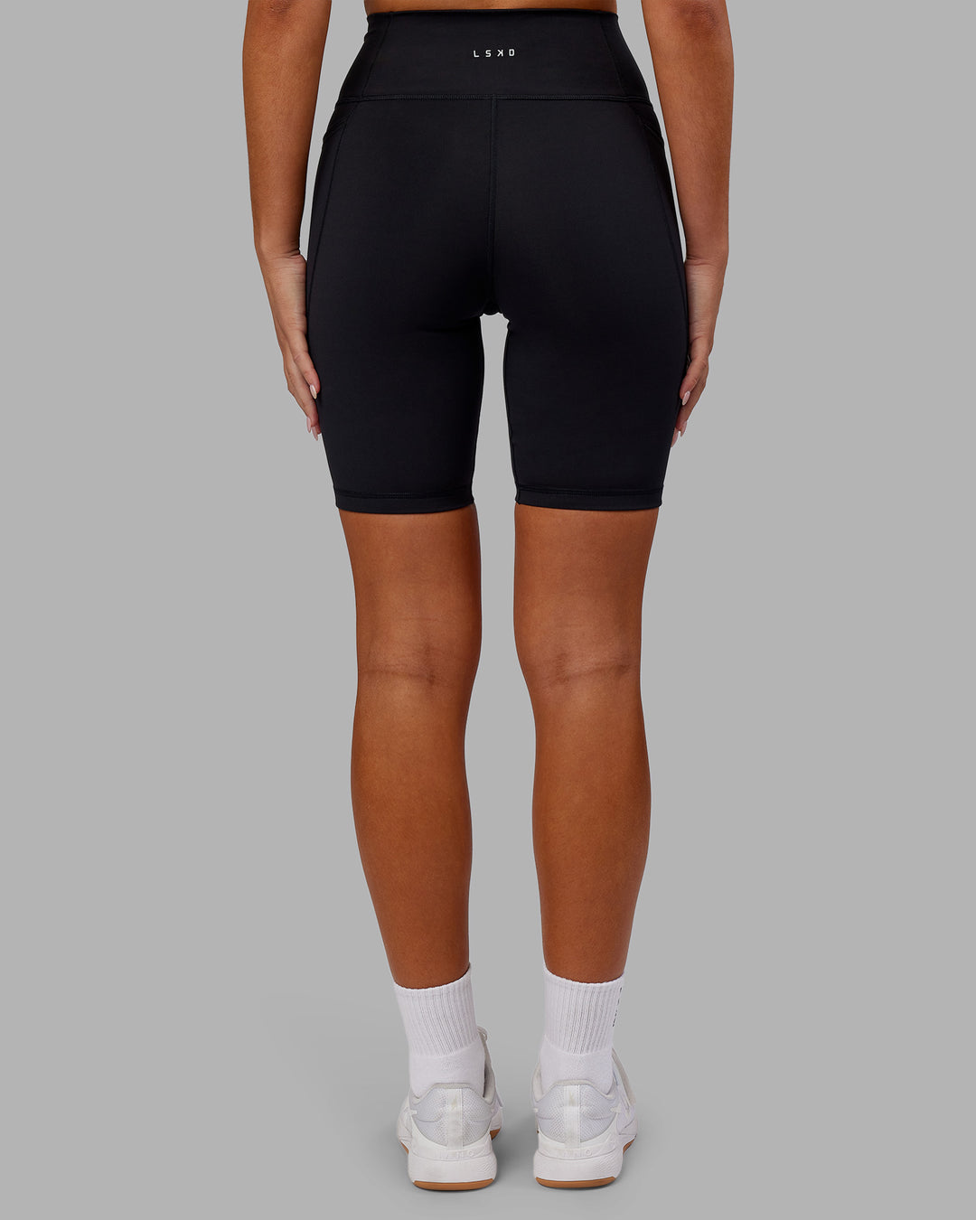 Woman wearing Fusion Ultra High-Rise 9" Short Pockets - Black | Model:Kirstyn | Size:S - view 4