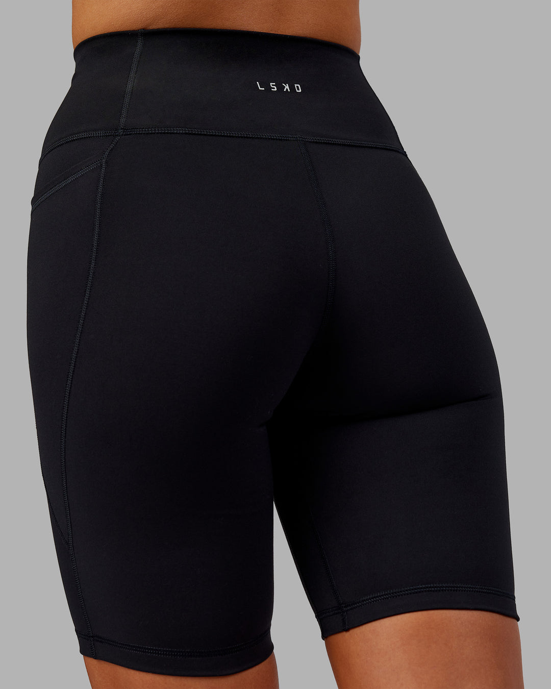 Woman wearing Fusion Ultra High-Rise 9" Short Pockets - Black | Model:Kirstyn | Size:S - view 7