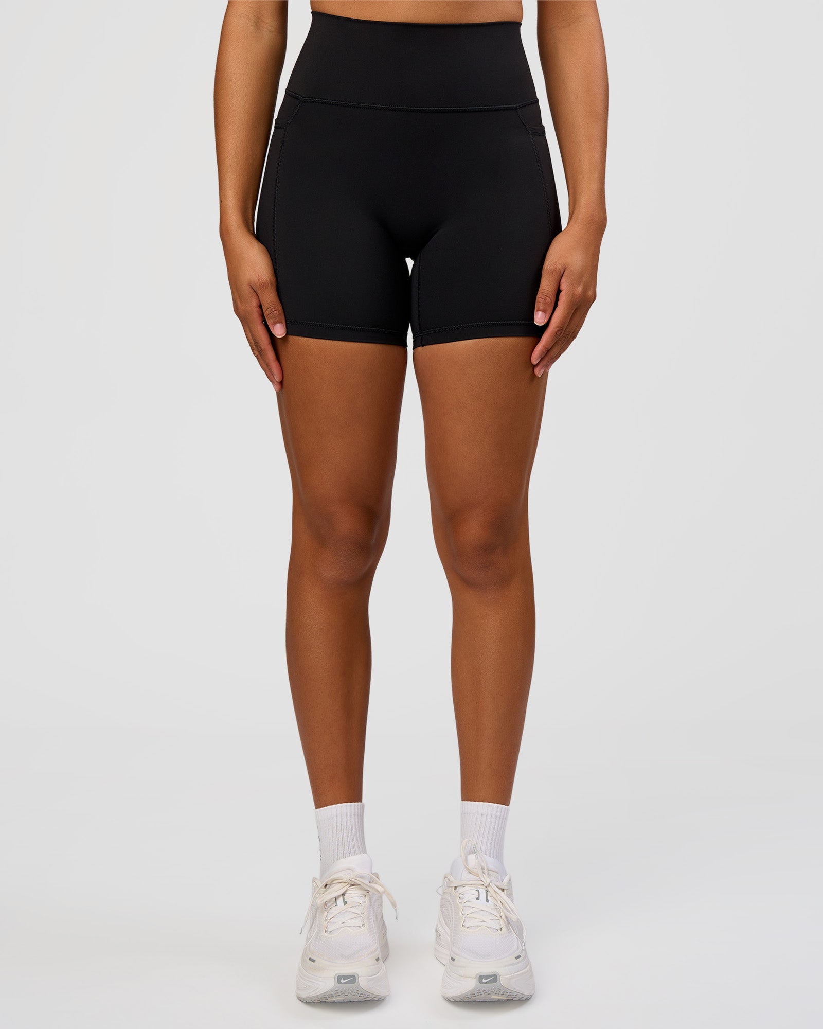 Woman wearing Fusion Graphic Ultra High-Rise 6" Short Pockets - Black-Radiate | Model:Rosie | Size:S