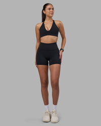 Woman wearing Fusion High-Rise 4" Short Pockets - Black | Model:Rhiley | Size:S | Thumbnail Index: 1