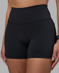 Woman wearing Fusion High-Rise 4" Short Pockets - Black | Model:Rhiley | Size:S | Thumbnail Index: 5