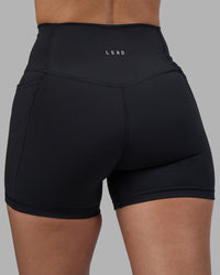 Woman wearing Fusion High-Rise 4" Short Pockets - Black | Model:Rhiley | Size:S | Thumbnail Index: 7