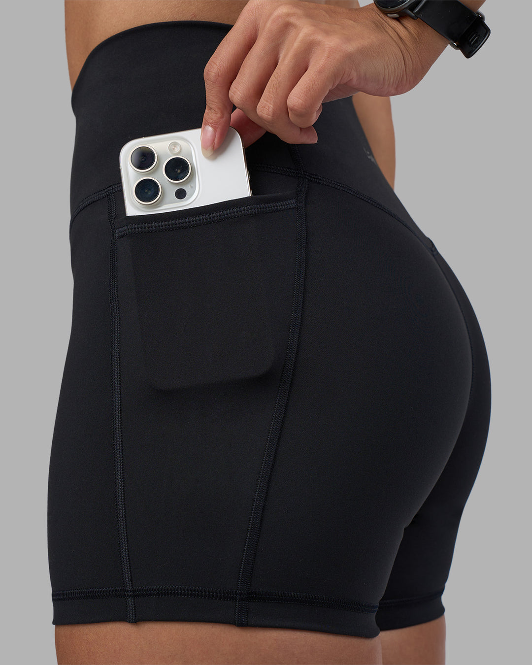 Woman wearing Fusion High-Rise 4" Short Pockets - Black | Model:Rhiley | Size:S - view 3