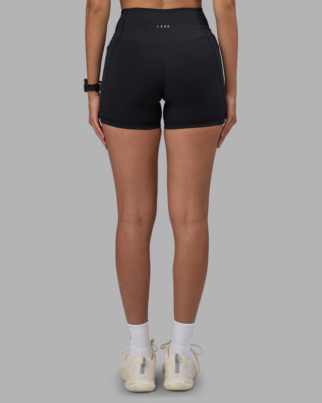 Woman wearing Fusion High-Rise 4" Short Pockets - Black | Model:Rhiley | Size:S - view 4