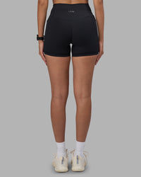 Woman wearing Fusion High-Rise 4" Short Pockets - Black | Model:Rhiley | Size:S | Thumbnail Index: 3