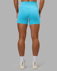 Woman wearing Fusion High-Rise 4" Short Pockets - Blue Atoll | ModelGeorgia | Size:S | Thumbnail Index: 3