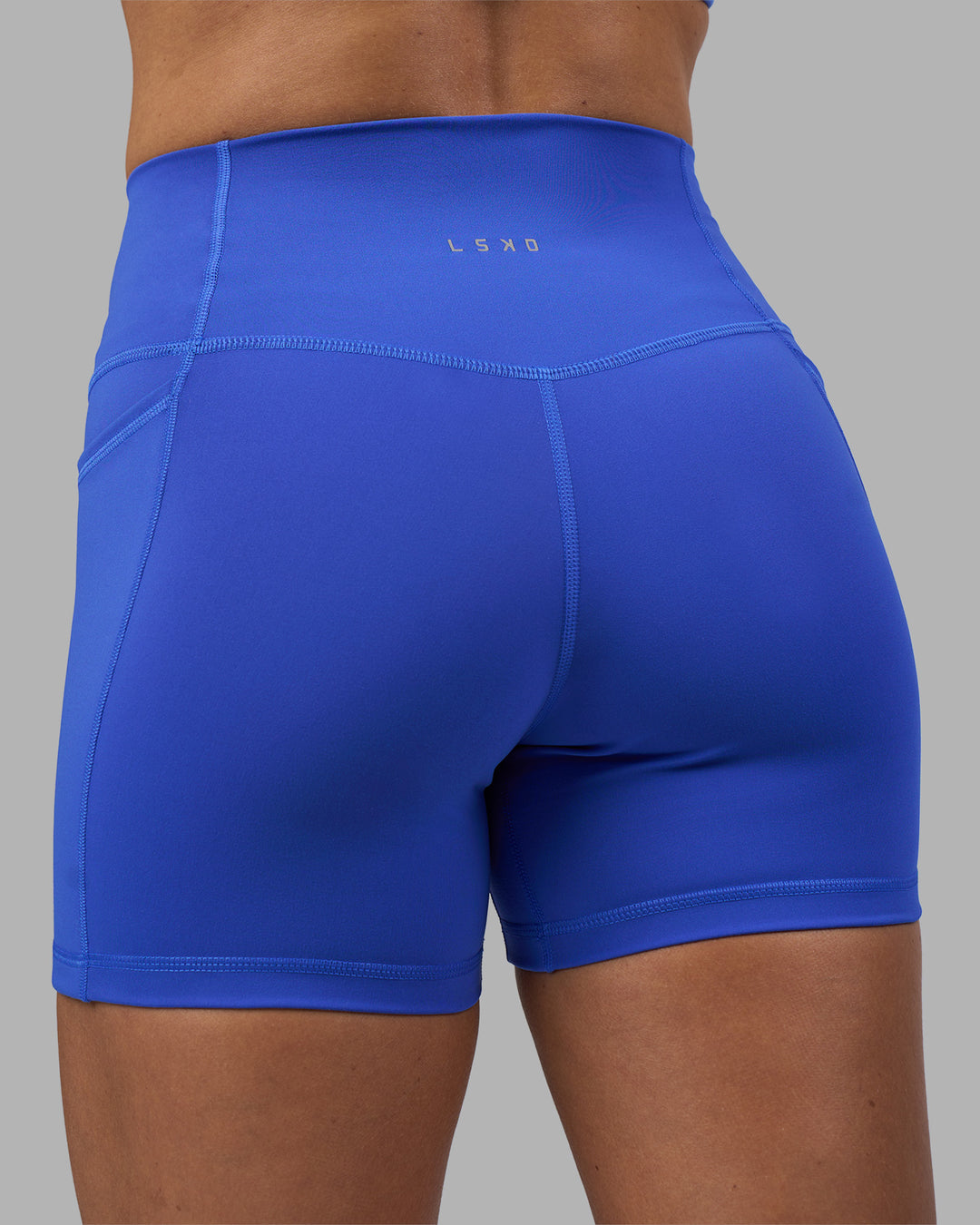 Woman wearing Fusion High-Rise 4" Short Pockets - Power Cobalt | Model:Hannah | Size:S - view 8