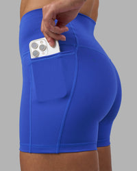Woman wearing Fusion High-Rise 4" Short Pockets - Power Cobalt | Model:Hannah | Size:S | Thumbnail Index: 1