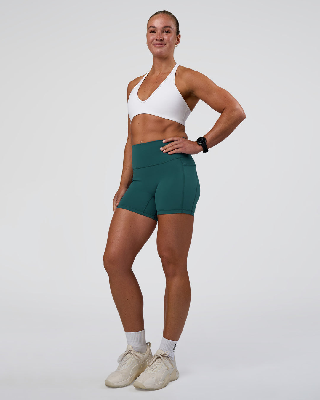 Woman wearing Fusion High-Rise 4" Short Pockets - Transformative Teal | Model:Sav | Size:S - view 5