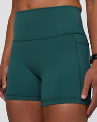 Woman wearing Fusion High-Rise 4" Short Pockets - Transformative Teal | Model:Sav | Size:S | Thumbnail Index: 0