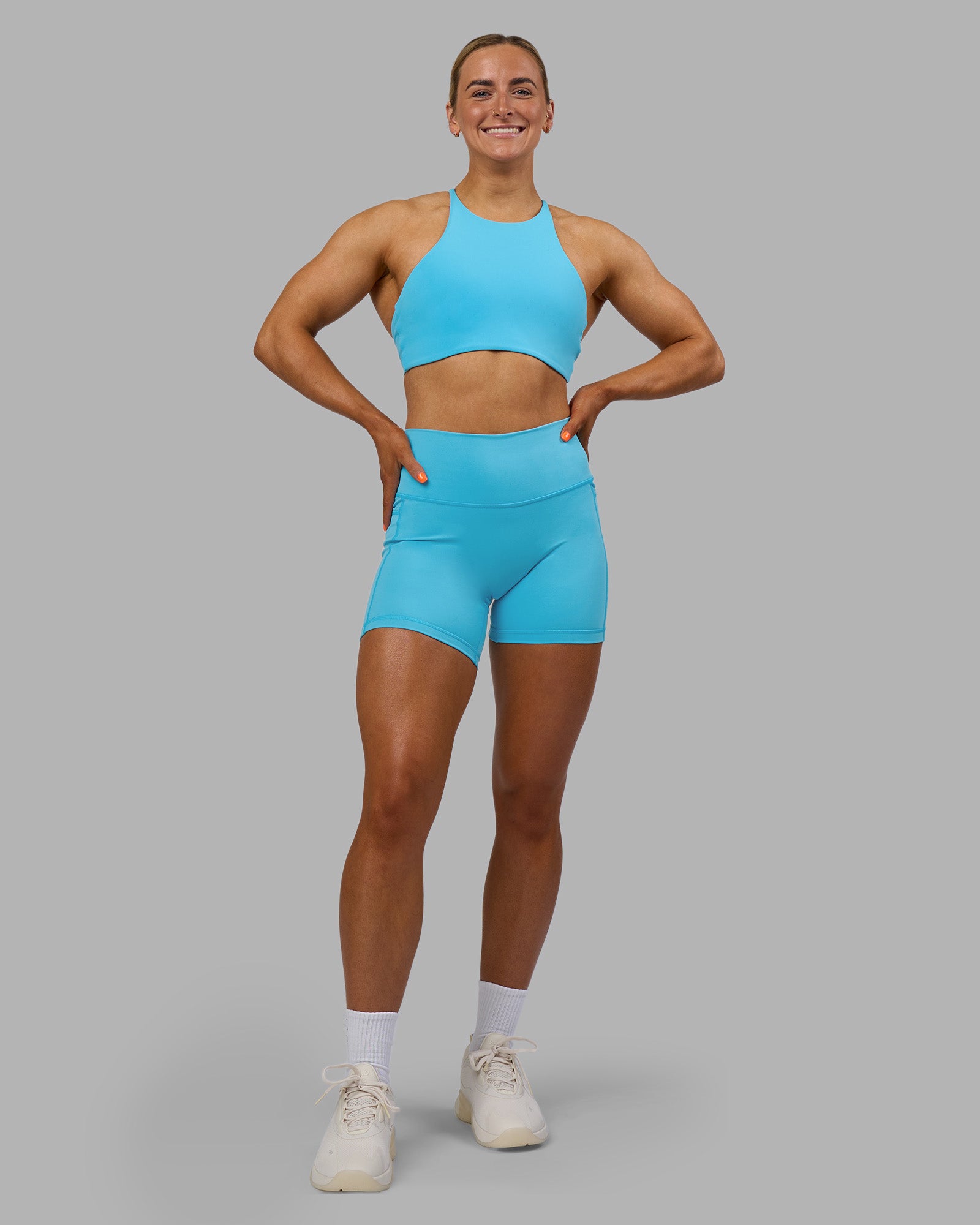 Woman wearing Fusion High-Rise 6" Short Pockets - Blue Atoll | Model:Georgia | Size:S