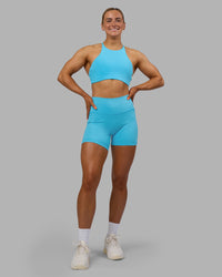 Woman wearing Fusion High-Rise 6" Short Pockets - Blue Atoll | Model:Georgia | Size:S | Thumbnail Index: 0