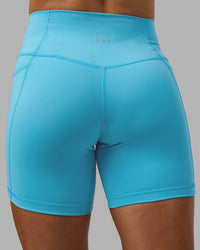 Woman wearing Fusion High-Rise 6" Short Pockets - Blue Atoll | Model:Georgia | Size:S | Thumbnail Index: 7