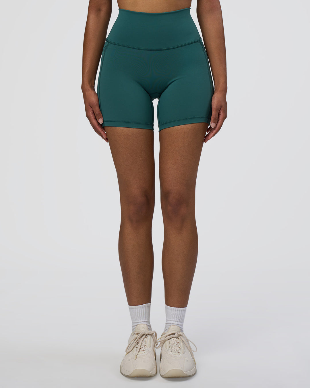Woman wearing Fusion High-Rise 6" Short Pockets - Transformative Teal | Model:Jordan | Size:S - view 1