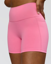 Woman wearing Fusion High-Rise 4" Short Pockets - Candy Pink | Model:Rosie | Size:S | Thumbnail Index: 0