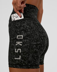 Woman wearing Fusion Icon Ultra High-Rise 6" Short Pockets - Energy Print Black | Model:Amity | Size:S | Thumbnail Index: 0
