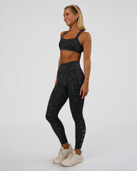 Woman wearing Fusion Icon Ultra High-Rise Full Length Legging Pockets - Energy Print Black-Reflective | Model:Amity | Size:S | Thumbnail Index: 5