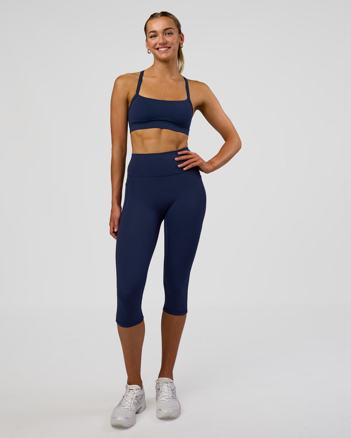 Woman wearing Fusion Ultra High-Rise 3/4 Legging Pockets - Future Navy | Model:Evie | Size:S