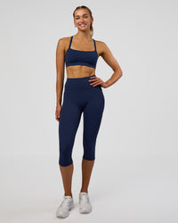 Woman wearing Fusion Ultra High-Rise 3/4 Legging Pockets - Future Navy | Model:Evie | Size:S | Thumbnail Index: 1