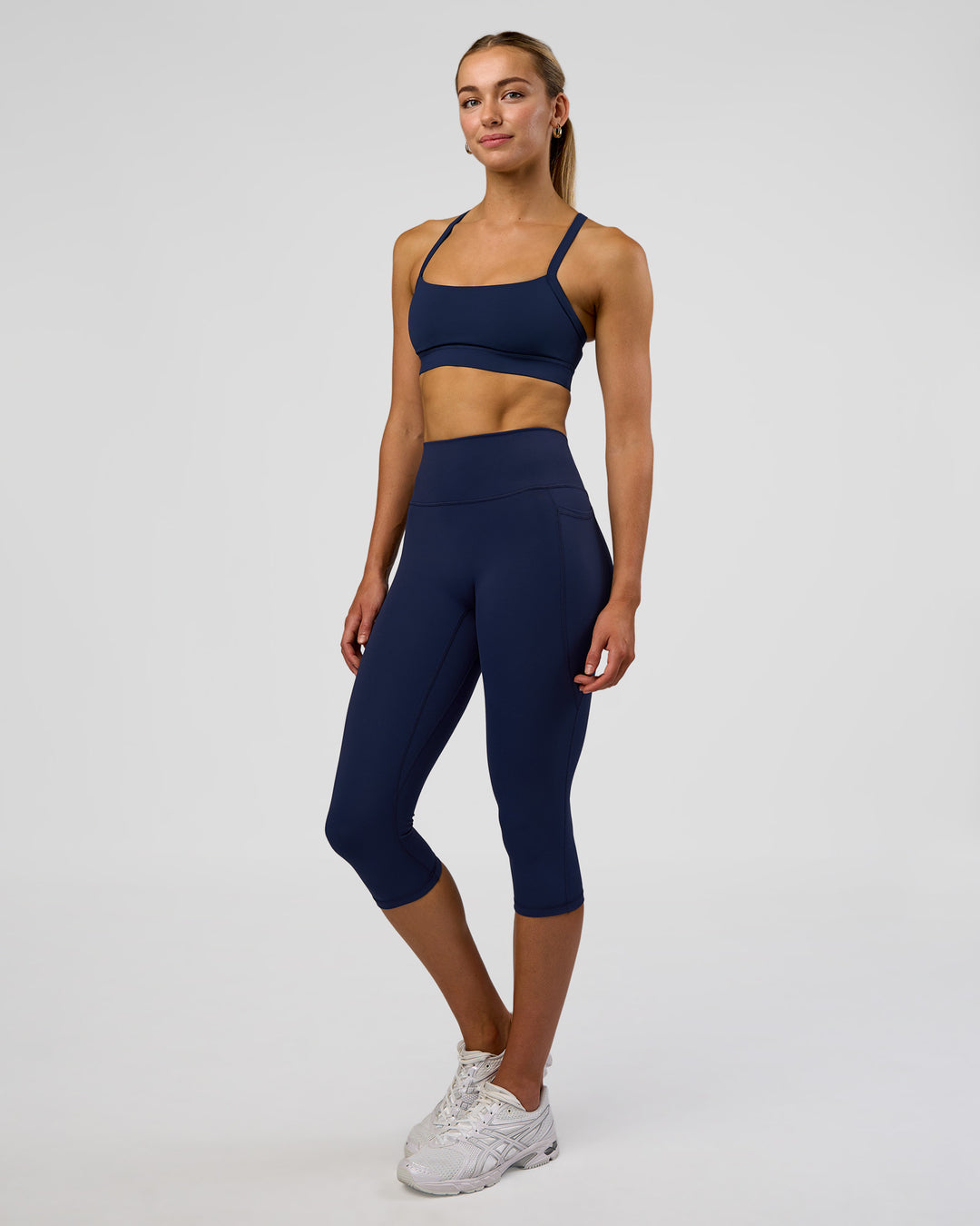 Woman wearing Fusion Ultra High-Rise 3/4 Legging Pockets - Future Navy | Model:Evie | Size:S - view 5