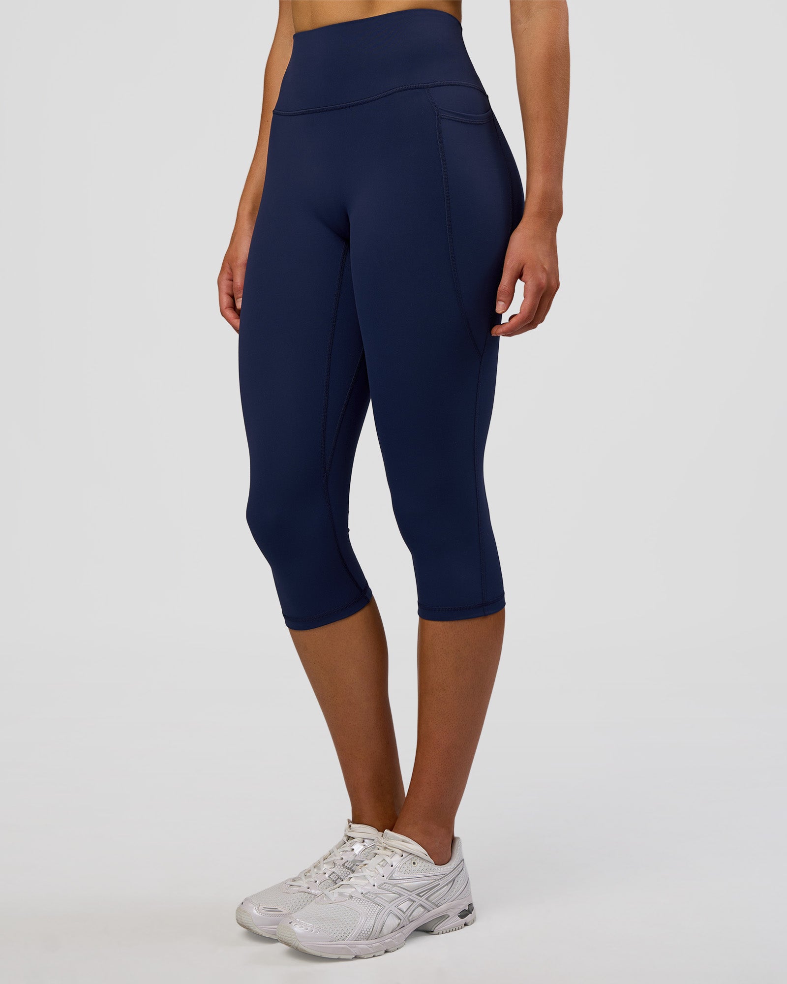 Woman wearing Fusion Ultra High-Rise 3/4 Legging Pockets - Future Navy | Model:Evie | Size:S