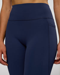 Woman wearing Fusion Ultra High-Rise 3/4 Legging Pockets - Future Navy | Model:Evie | Size:S | Thumbnail Index: 2