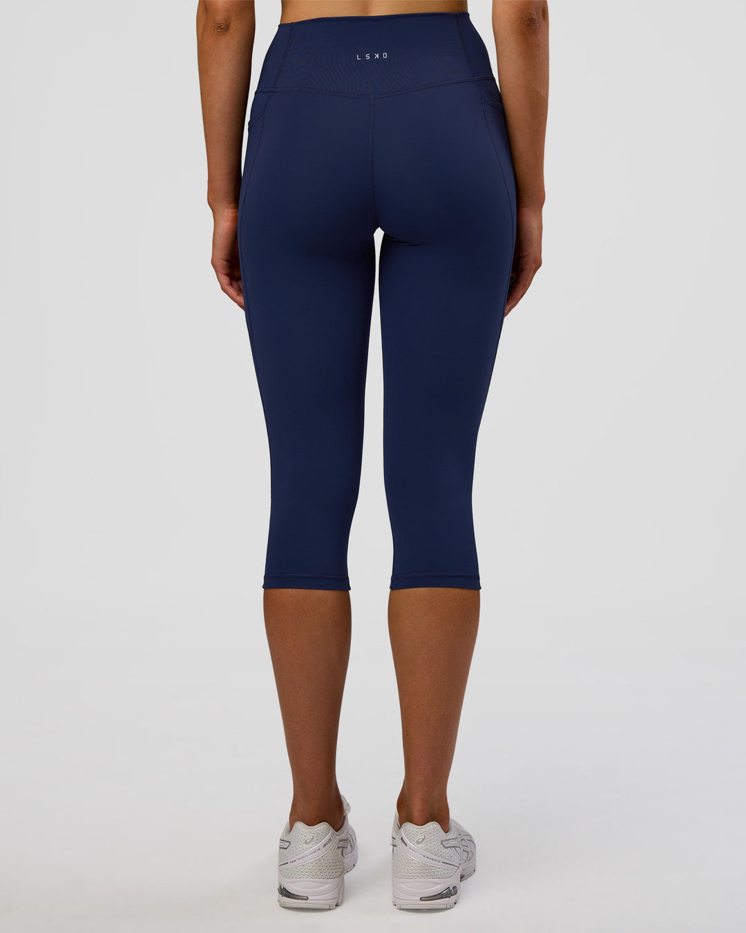 Woman wearing Fusion Ultra High-Rise 3/4 Legging Pockets - Future Navy | Model:Evie | Size:S - view 4