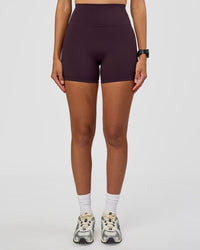 Woman wearing Fusion Ultra High-Rise 4" Short - Midnight Plum | Set:true | Angle:front | Model:Rhiley | Size:S | Thumbnail Index: 2