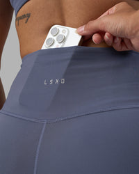 Woman wearing Fusion Ultra High-Rise 4" Short - Night Shadow | Set:true | Angle:closeup | Model:Rhiley | Size:S | Thumbnail Index: 5