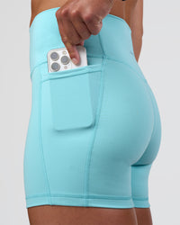 Woman wearing Fusion Ultra High-Rise 4" Short Pockets - Baltic Sea | Set:true | Angle:closeup | Model:Sav | Size:S | Thumbnail Index: 0