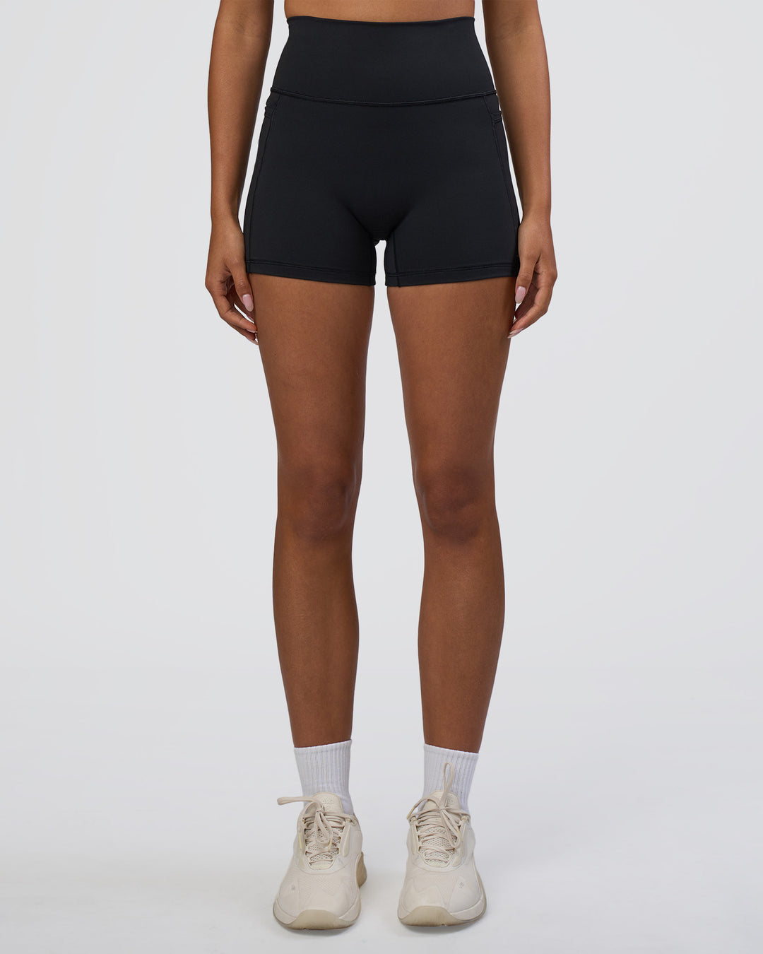 Woman wearing Fusion Ultra High-Rise 4" Short Pockets - Black | Set:true | Angle:front | Model:Ruby | Size:S - view 8