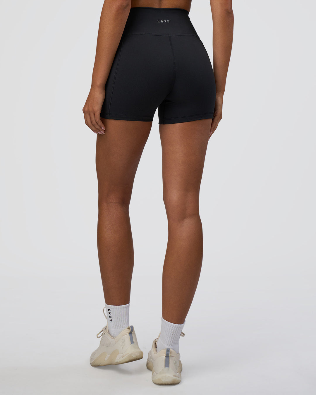 Woman wearing Fusion Ultra High-Rise 4" Short Pockets - Black | Set:true | Angle:back | Model:Ruby | Size:S - view 4