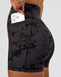 Woman wearing Fusion Ultra High-Rise 4" Short Pockets - Black Tie Dye | Set:true | Angle:closeup | Model:Amity | Size:S | Thumbnail Index: 0
