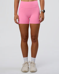 Woman wearing Fusion Ultra High-Rise 4" Short Pockets - Candy Pink | Set:true | Angle:front | Model:Emelia | Size:S | Thumbnail Index: 7