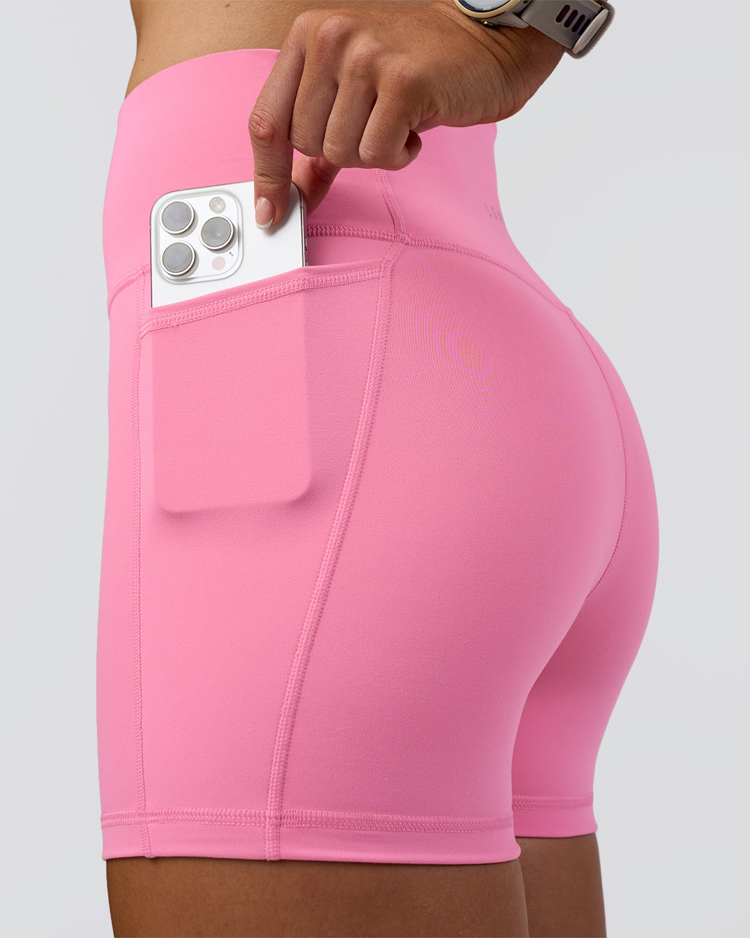 Woman wearing Fusion Ultra High-Rise 4" Short Pockets - Candy Pink | Set:true | Angle:closeup | Model:Emelia | Size:S - view 2